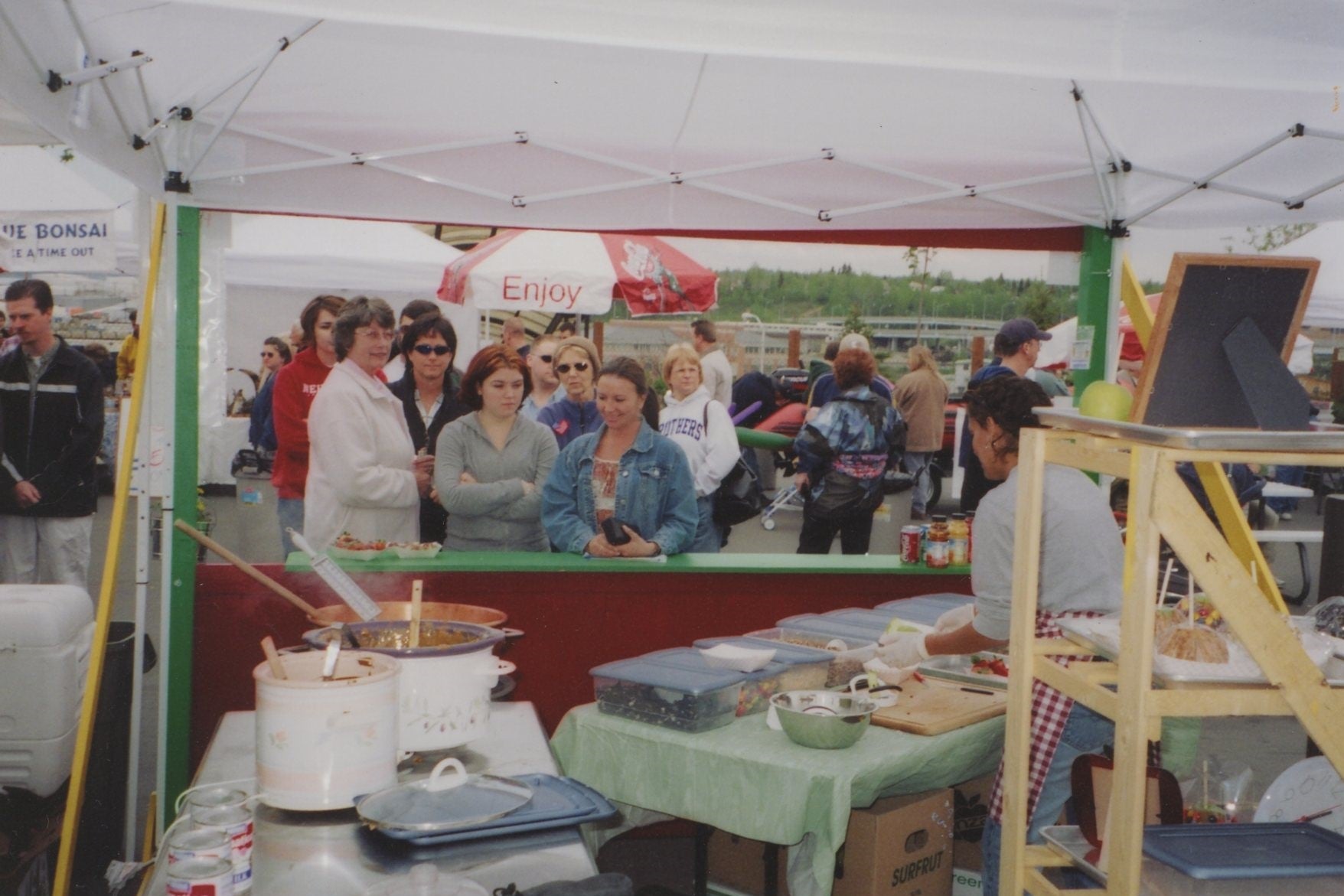 Line of people watching Caroline make caramel apples